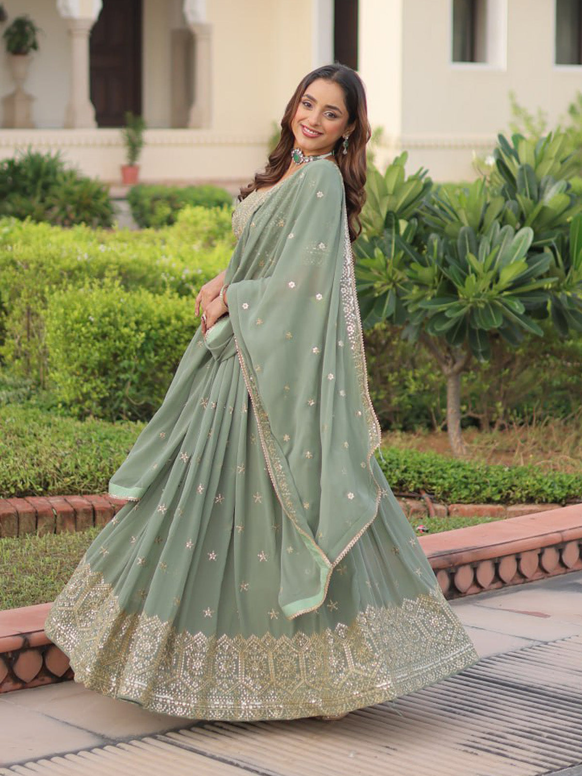 Premium faux georgette lehenga set with sequins, zari embroidery and stylish lace border dupatta. Ideal for festive wear, engagements and wedding celebrations.