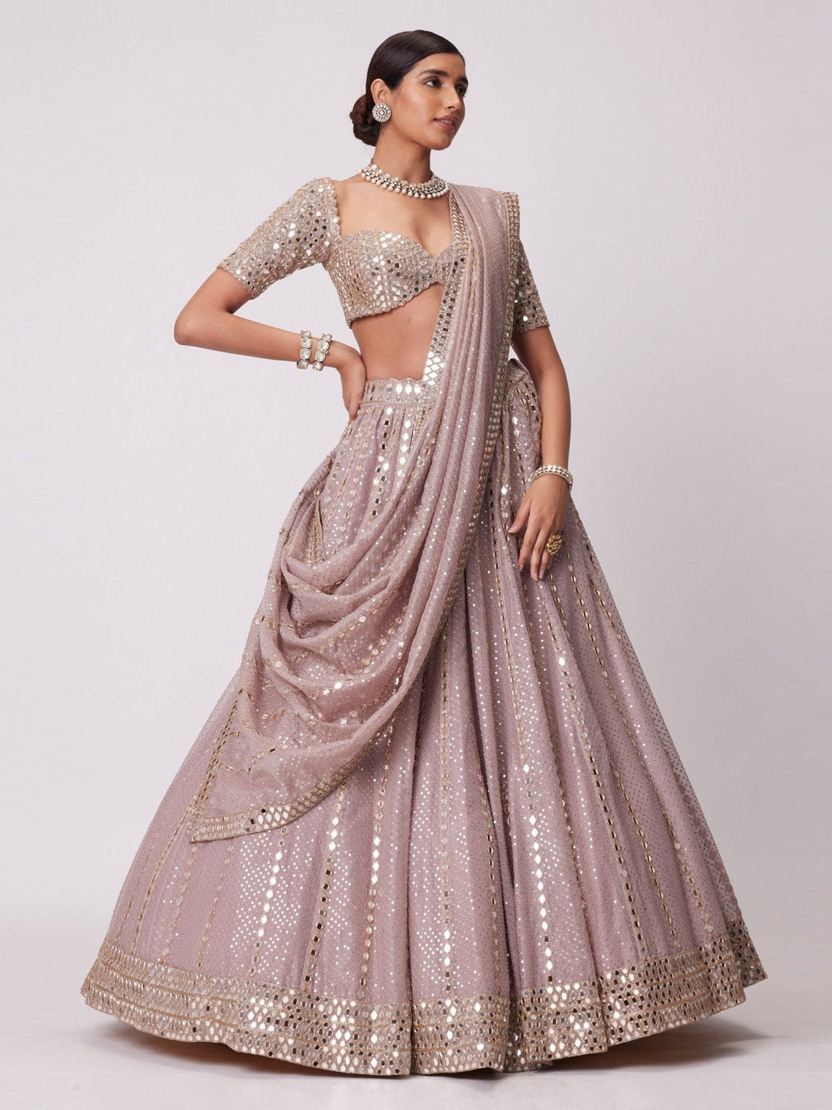 Discover FEALDEAL designer mauve wedding lehenga choli with paper mirror embroidery, heavy dupatta and 3.2 meter flared silhouette.