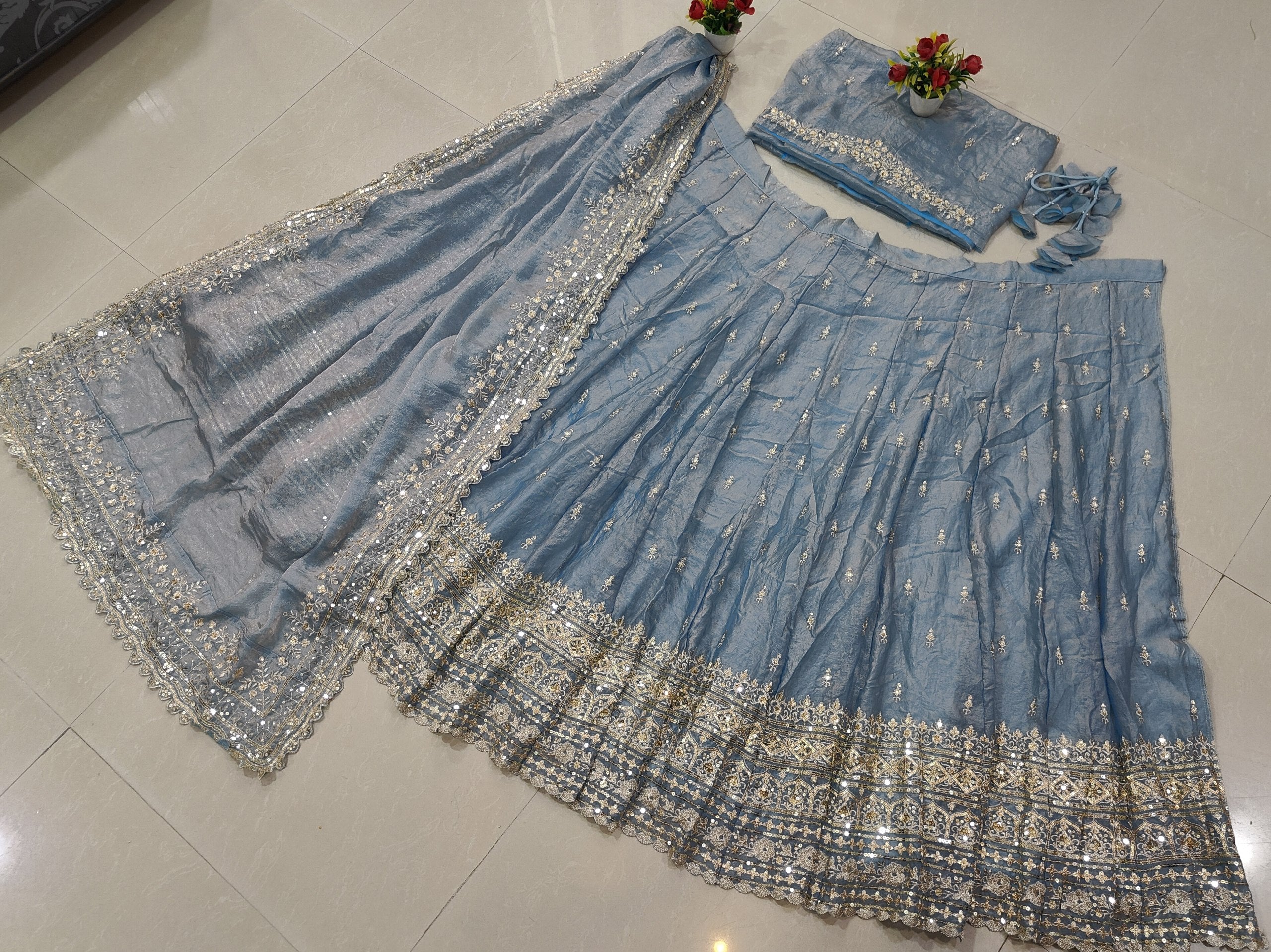 Shop the best silk lehenga choli for weddings with dusty blue golden shading, semi-stitched 3.6M flair, embroidered blouse and stitched dupatta.