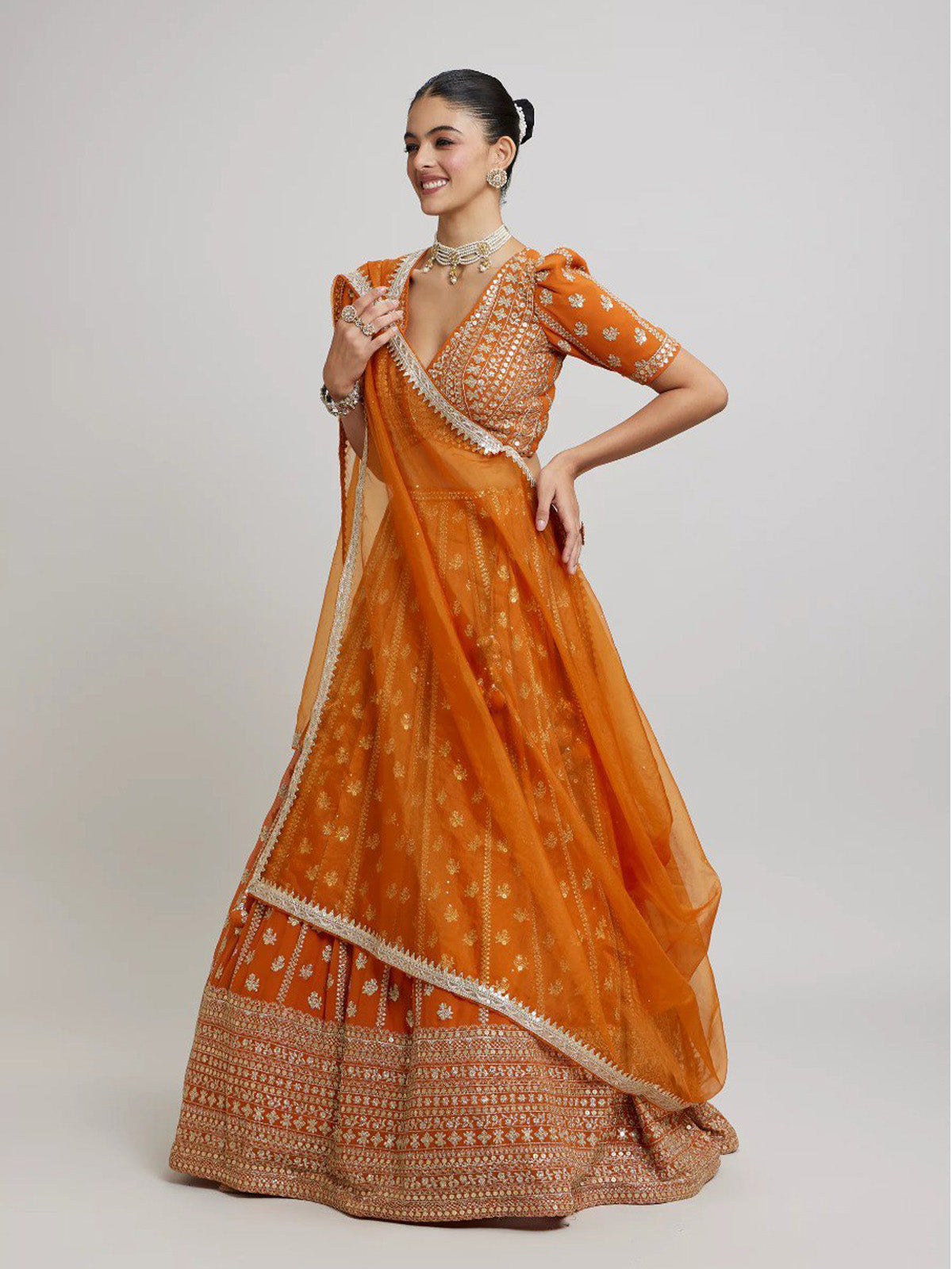 Elegant orange faux georgette lehenga choli with 4.25 meter flare, embroidered blouse and designer dupatta. Perfect for receptions, weddings and festive wear.